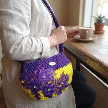 Purple and yellow bag with a purple flower
