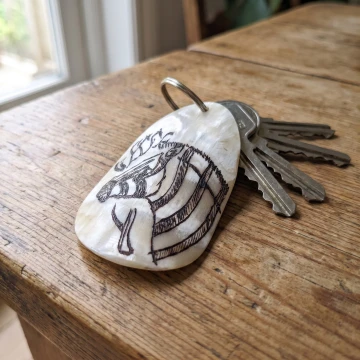 Manjenjenje Zebra scrimshawed bone keychain handcraft from Zimbabwe