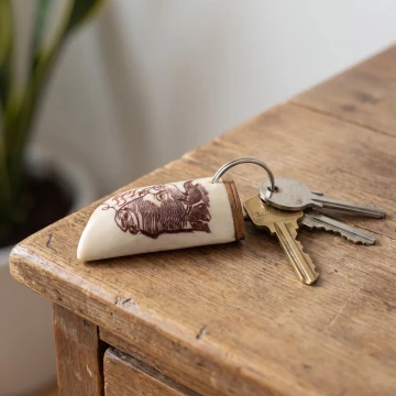 Buffalo scrimshawed keychain made from wood and cow bone with curved edges